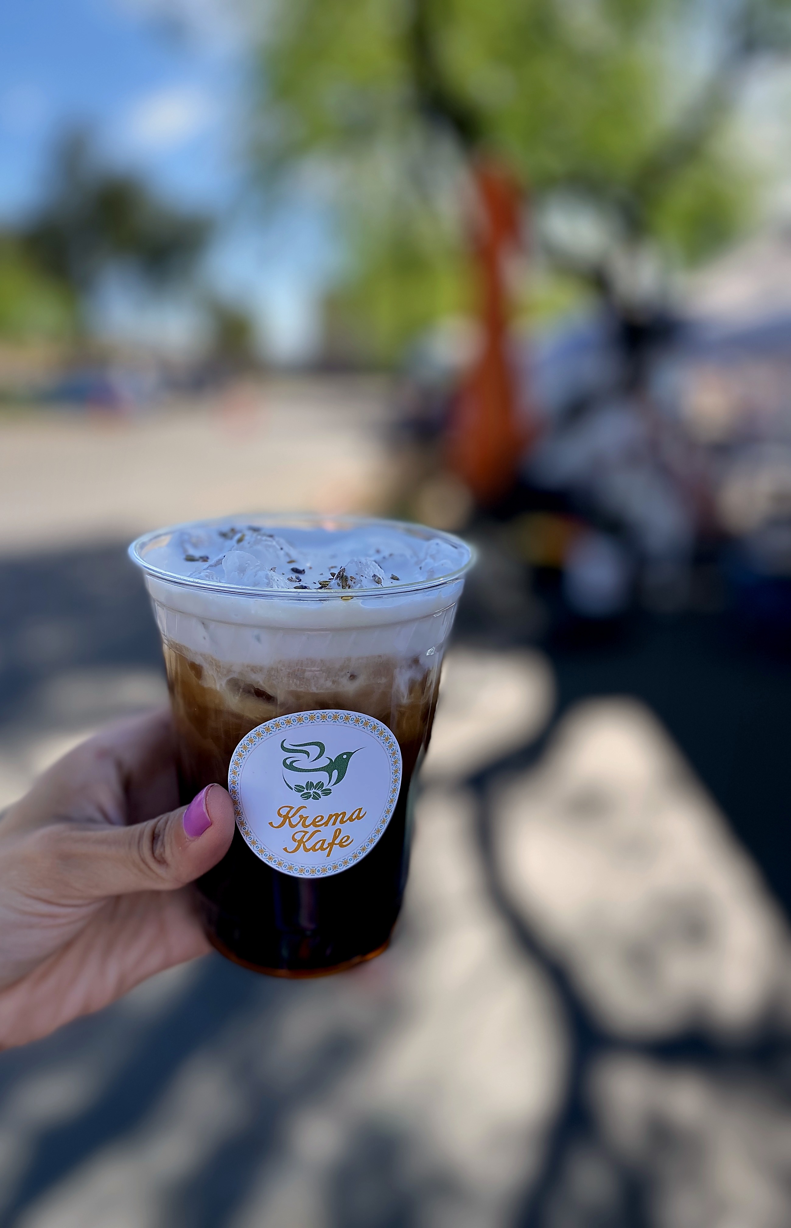 Krema Kafe barista holding artisan coffee drink at Phoenix pop-up event